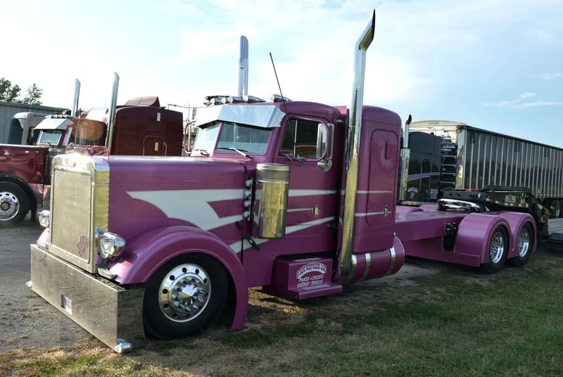 A purple custom-painted Peterbilt semi truck